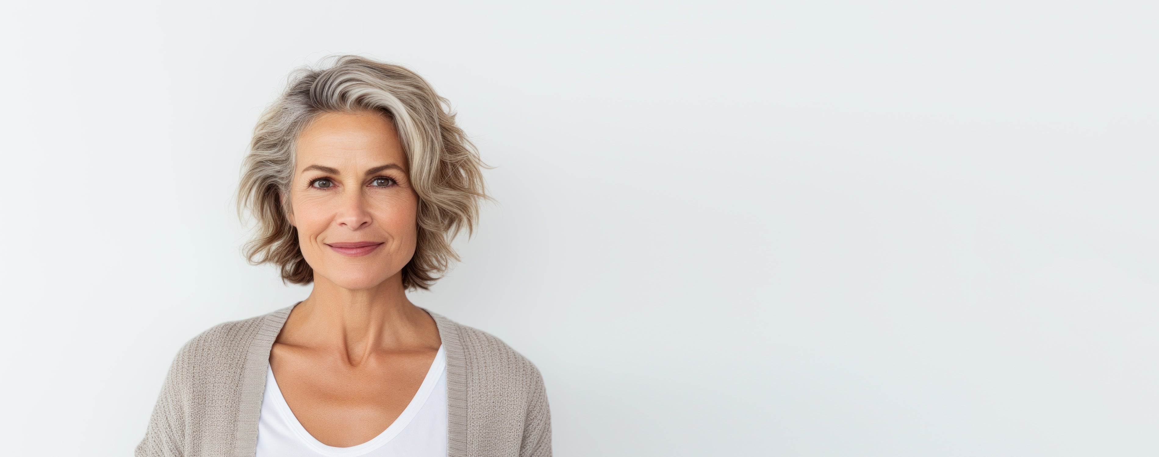 Frau mittleren Alters mit halblangen dunkelblonden Haaren lächelt in die Kamera.